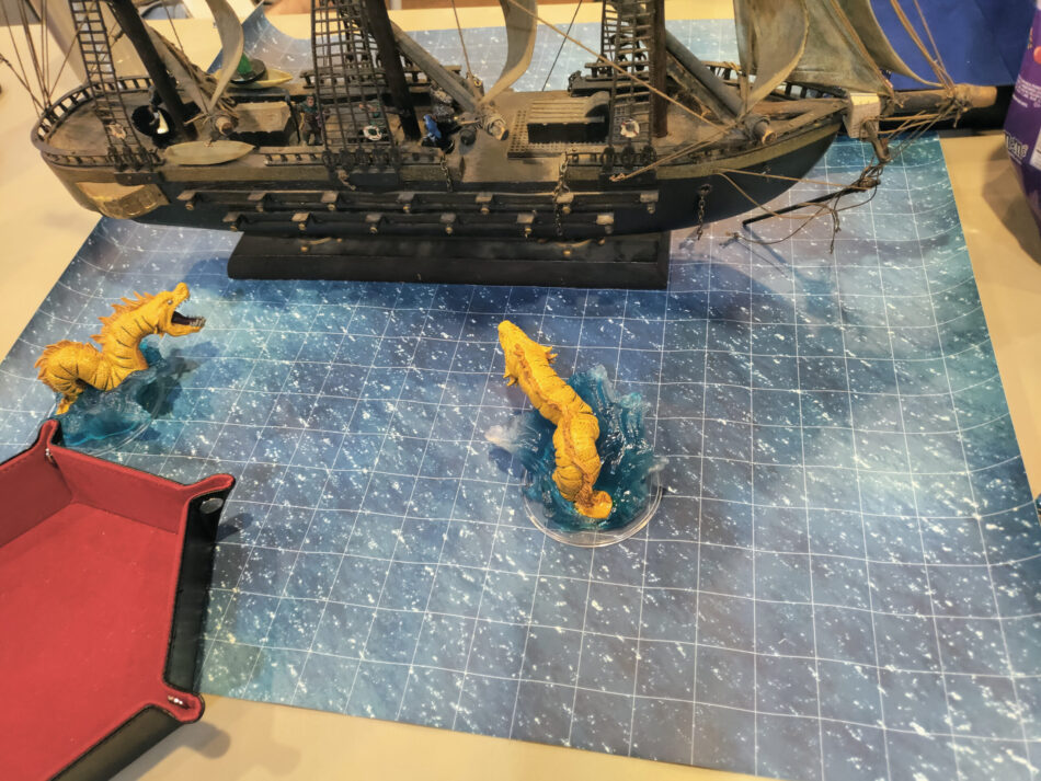 A ship and dragons from a D&D game at IPCON 2023. (Andrew Bucholtz photo.)